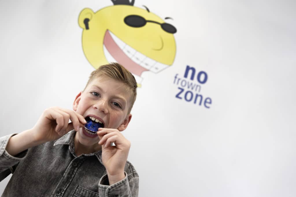 Child trying on plate at Fine Orthodontist Sydney Bondi