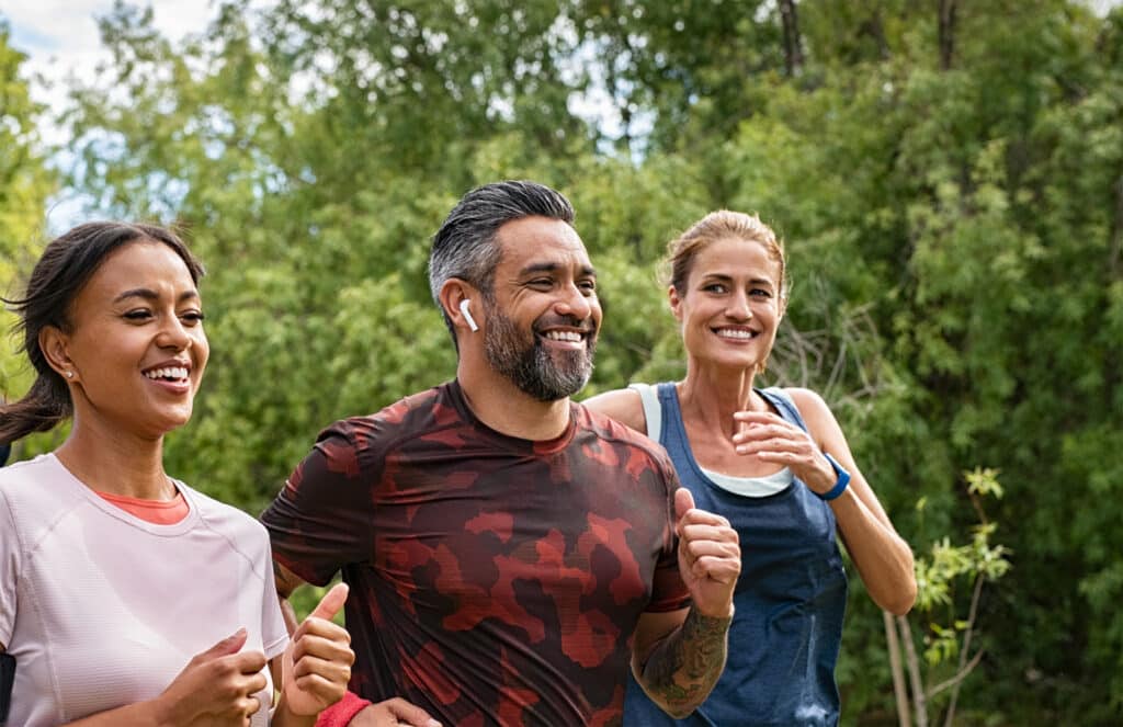Adults exercising outdoors, active lifestyle concept.