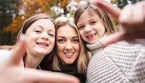 Family shown together, mother with two daughters.