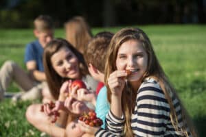 Eating with braces - group outdoors eating grapes during braces treatment.