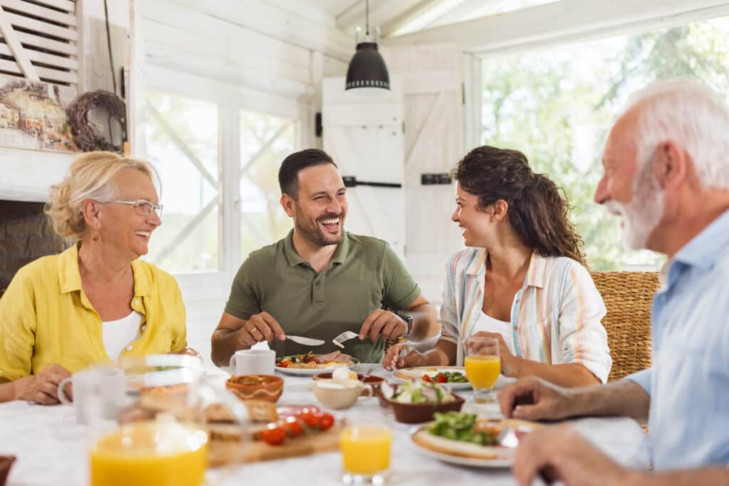 Group of adults socialising, eating and drinking during Invisalign treatment.