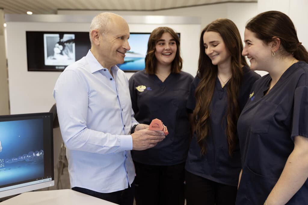 Dr Martin Fine and staff discussing an orthodontic case at the Fine Orthodontist Bondi Junction clinic.