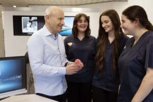 Dr Martin Fine and staff discussing an orthodontic case at the Fine Orthodontist Bondi Junction clinic.